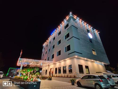 a building with christmas lights on top of it at Vadpadraka Hotel And Resort in Vadodara