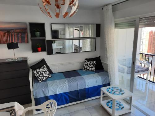 a bedroom with a bed and a balcony at HAPPY LOiX 1 APARTMENT in Benidorm