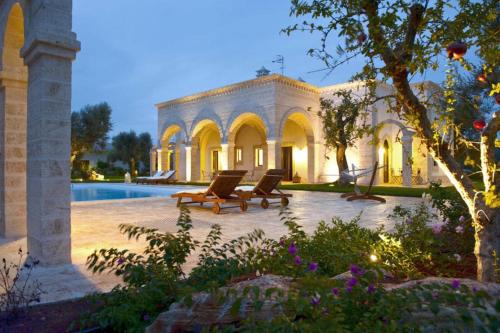 a house with two lounge chairs and a swimming pool at Donna Lucrezia in Pezze di Greco