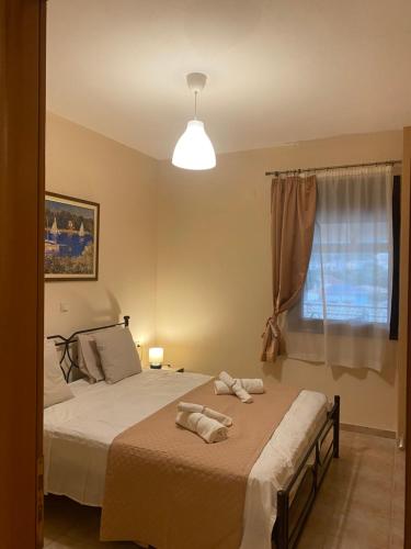 a bedroom with two beds with towels on them at Seavota Comfort Apartment in Sivota