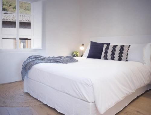 a white bedroom with a large white bed with pillows at Locanda San Silvestro - Meride in Mendrisio