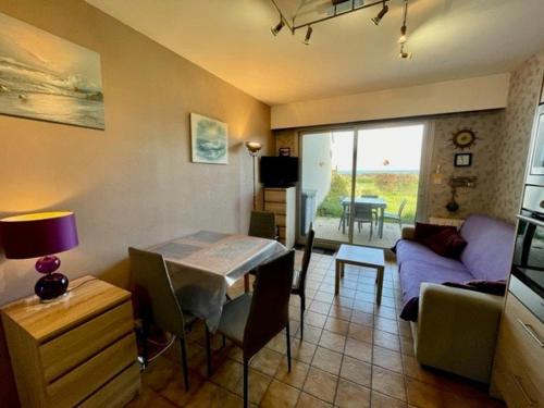 un salon avec une table et un canapé dans l'établissement Saint-Pierre-Quiberon - Appartement 2P 28m² - 4 pers - Jardin clôturé - Animaux acceptés - FR-1-478-114, à Saint-Pierre-Quiberon