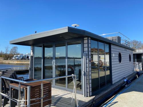 a small cabin on a boat on the water at Hausboot Fjord Claudia Schleswig in Schleswig