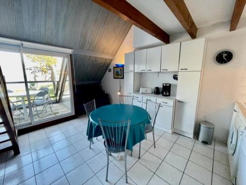 a kitchen with a table and chairs in a room at Appartement bord de mer à Saint-Pierre-Quiberon avec balcon et garage - FR-1-478-181 in Saint-Pierre-Quiberon