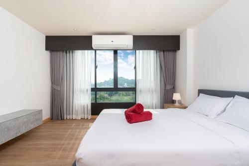 a bedroom with a white bed with a red heart on it at Central Hill View 1BR Apartment A940 C in Ban Ket Ho