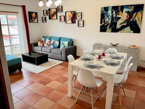 a living room with a white table and chairs at Sun & Zen - Spacious and Sunny in São Martinho do Porto