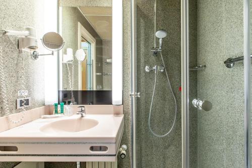 a bathroom with a sink and a shower at HOTIDAY Hotel Milano Turro in Milan