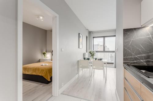 um quarto com uma cama e uma mesa com cadeiras em City View Apartments em Varsóvia