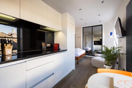 a kitchen and living room with a large window at Hausd Flex - Covent Garden in London