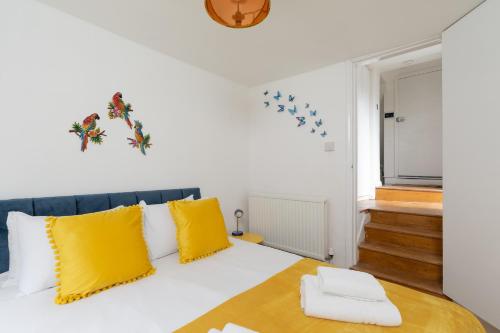 Zimmer mit einem Bett und gelben Kissen in der Unterkunft 2 bed 2 bath APT Central London in London
