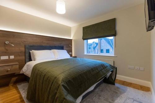 a bedroom with a large bed and a window at LUXURY TOWN CENTRE APARTMENT in Cookstown