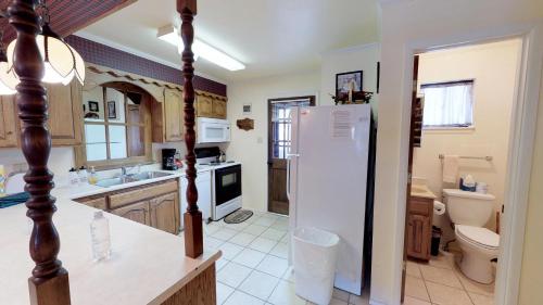 a kitchen with a white refrigerator and a toilet at Claim Jumper 4 Townhouse With High Speed Wifi in Red River