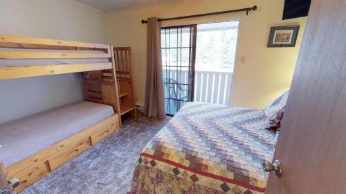 a bedroom with a bunk bed and a window at Claim Jumper 4 Townhouse With High Speed Wifi in Red River