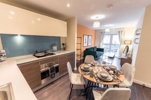 a kitchen and dining room with a table and chairs at ALTIDO Modern flats in central Birmingham, next to business district in Birmingham