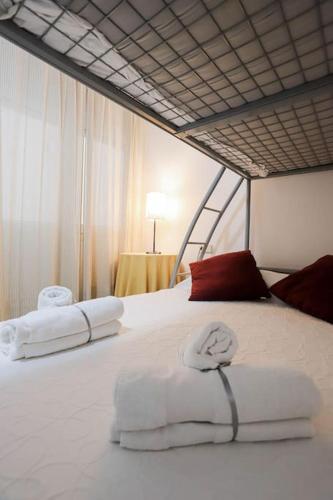 a white bed with two towels on it at Bahía Relax Puerto de Sóller in Port de Soller