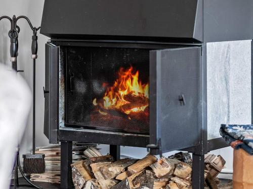 a stove with a fire inside of it at 12 person holiday home in Nösund-By Traum in Nösund