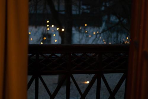 a view of a window with lights in the rain at Kastanienhof Pfettrach in Altdorf