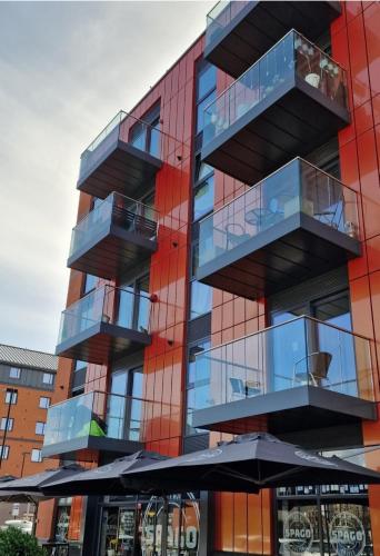 a building with balconies on the side of it at Beautiful 1 Bedroom Apartment with parking in Gloucester Docks in Gloucester