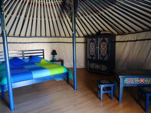 a bedroom with a bed in a yurt at Nomad Planet in Fiães do Rio