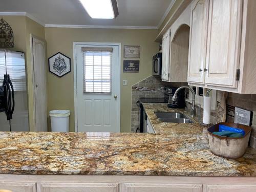 a kitchen with a counter top and a sink at Claim Jumper 9 Townhouse With High Speed Wifi in Red River