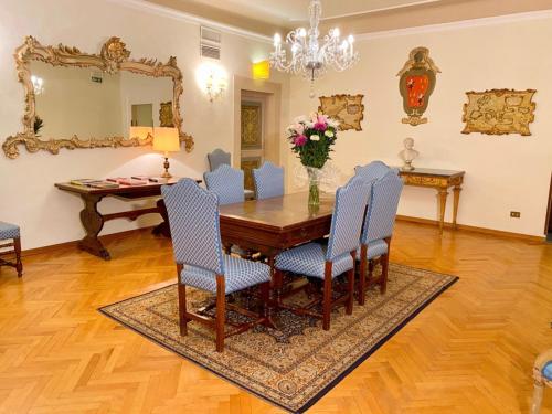 a dining room with a table and chairs and a mirror at Hotel Martelli in Florence