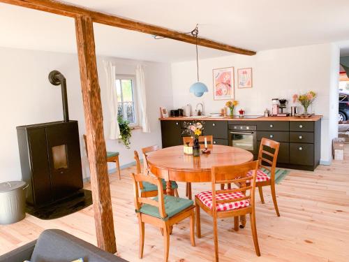 a kitchen and dining room with a wooden table and chairs at Ferienhaus Feni in Neckargemünd