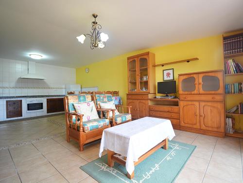 a kitchen with a table and chairs in a room at Casa con vistas al mar en Playa de Foxos in Sanxenxo