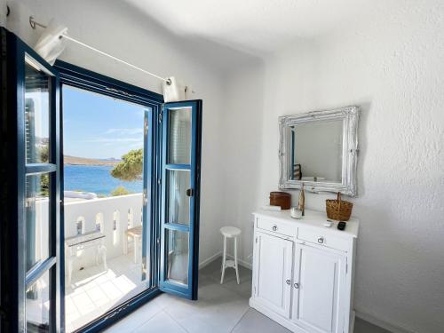 a white room with a door and a mirror at Ocean Vibes Villa by Angels Group Mykonos in Mýkonos City
