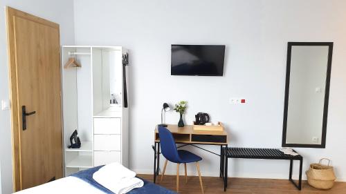 una camera da letto con scrivania, sedia e specchio di Sleep Port a Danzica