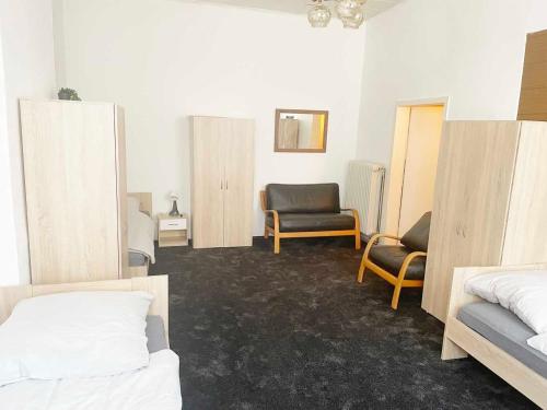 a room with two beds and a chair at Spacious 4 room apartment in Hanau in Hanau am Main