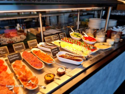 a buffet line with many different types of food at Hotel am Kurpark in Zinnowitz