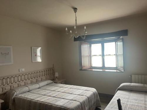 a bedroom with two beds and a window at Posada La Solana - Adults Only in Santillana del Mar