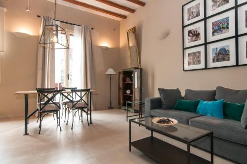 a living room with a couch and a table at Weflating Suites Sant Antoni Market in Barcelona