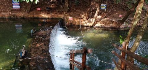 a pool of water with a net in a river at Apart no Águas da Serra - 115B in Rio Quente