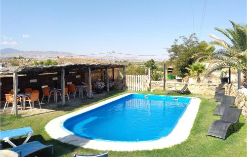 a swimming pool in the yard of a house at 2 Bedroom Cozy Home In Baza in Baza