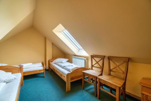 a room with three beds and a skylight at Willa Paula in Ząb
