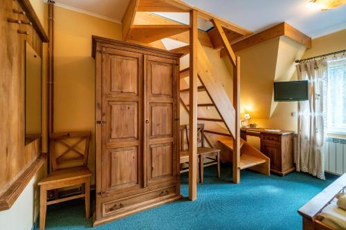 a room with a loft bed and a desk at Willa Paula in Ząb