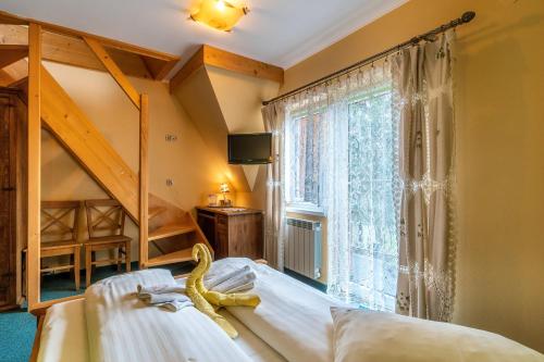 a bedroom with a bed and a large window at Willa Paula in Ząb