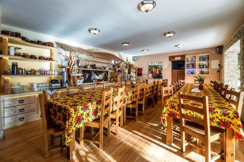 a dining room with wooden tables and chairs at Willa Paula in Ząb