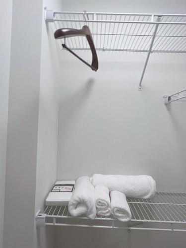 a towel rack in a bathroom with towels at Lux property great for 1 to 8 Guests-family trip ,5Beds 2Rooms Staycation with Gym and EV, proximity to Downtown and Beaches in West Palm Beach
