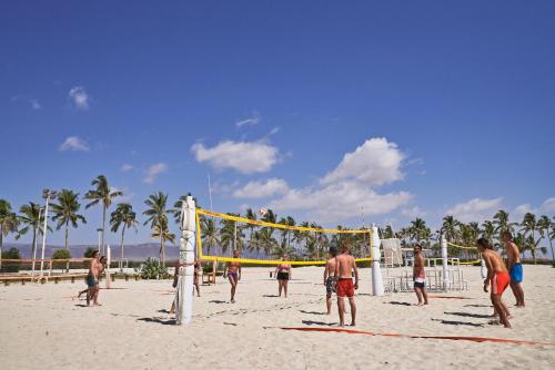 a group of people playing volleyball on a beach at Fanar Hotel & Residences in Salalah