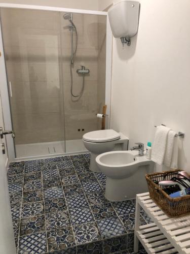 a bathroom with a shower and a toilet and a sink at IL SICOMORO in Sansepolcro