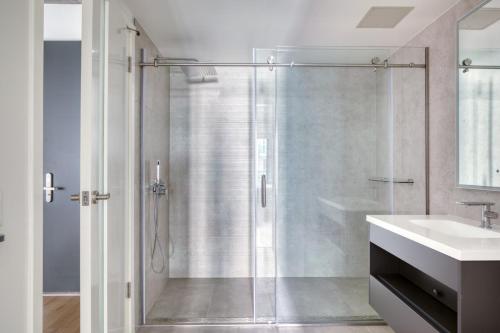 a bathroom with a glass shower and a sink at Downtown 1BR w Pool Gym WD nr Staples Center LAX-555 in Los Angeles
