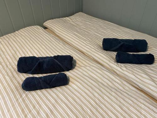 a bed with three blue pillows on it at Apartment Tromsdalen. Tromsø in Tromsø