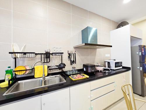 a kitchen with a sink and a counter top at D'Pristine Theme Suite by Nest Home at LEGOLAND in Nusajaya