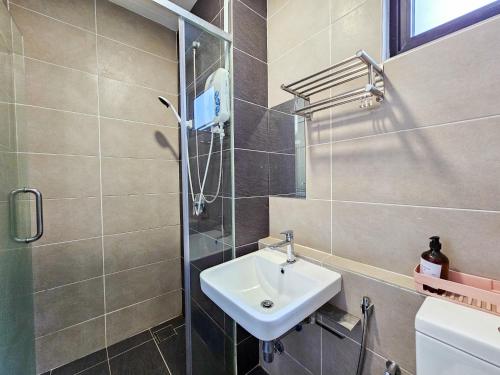 a bathroom with a sink and a shower at D'Pristine Theme Suite by Nest Home at LEGOLAND in Nusajaya