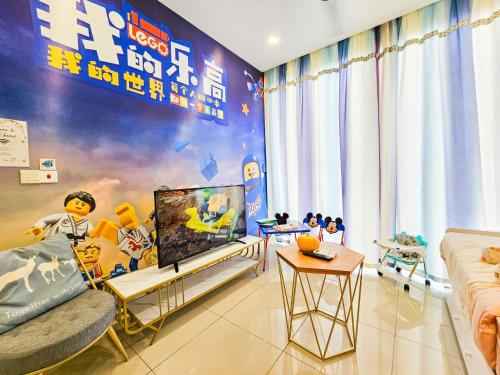 a living room with a tv and a couch at D'Pristine Theme Suite by Nest Home at LEGOLAND in Nusajaya