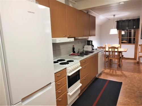 a kitchen with a refrigerator and a stove top oven at Holiday Club Åre Tegefjäll in Åre