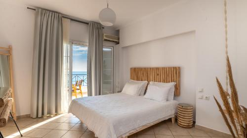 a bedroom with a bed with a view of the ocean at Sea Bliss Adults Only in Parga