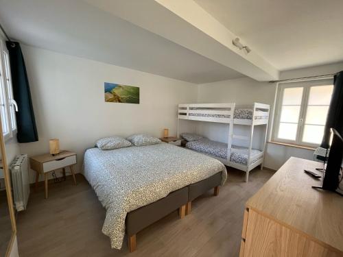 a bedroom with a bed and a bunk bed at Naturotel in Fort-Mahon-Plage